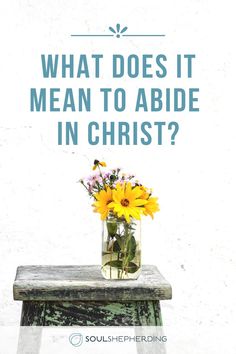 a vase filled with yellow flowers sitting on top of a wooden table next to a white wall