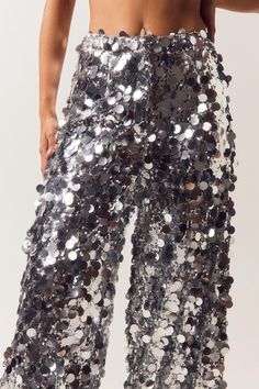 Sequins are always the right answer. Feel glam in our sequin pants, made in high quality sequin fabric, with a stellar wide leg fit, and a textured sequin design. Wear with the matching blazer for a stellar occasion look, perfect for bachelorette nights, engagement parties, and all of your upcoming events, or pair with jeans to dress it down. Disc Sequin Two Piece Wide Leg Pants High Quality Sequin Fabric Unique Large Sequin Design Fierce Wide Leg Silhouette Comforable High Waistline Matching Blazer Sold Separately Model wears a size M (US size 6/UK size 10). Sequin Wide Leg Pants, Sequin Two Piece, Sequin Jeans, Large Sequins, Going Out Trousers, Sequin Pants, Engagement Parties, Sequin Design, Uk Size 10