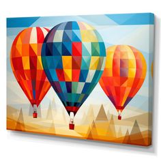 three hot air balloons flying in the sky with mountains and blue sky behind them canvas wall art print