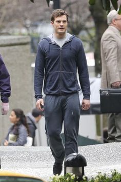 a young man walking down the street in his tracksuit