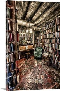 a room filled with lots of books next to a chair and book shelf full of books