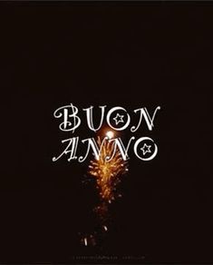 the words buon anno are lit up at night with fireworks in the background