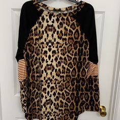 Size 2xl Pull Over Animal Print/Stripe Local Boutique Top/Tunic. Washed Never Worn. Smoke Free/Pet Free Home Casual Long Sleeve Tiger Print Tops, Black Tiger Print Long Sleeve Tops, Black Long Sleeve Top With Tiger Print, Black Long Sleeve Tiger Print Tops, Brown Tiger Print Top For Spring, Brown Tiger Print Tops For Spring, Spring Brown Tiger Print Tops, Casual Stretch Zebra Print Top, Casual Long Sleeve Zebra Print Tops