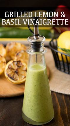 grilled lemon and basil vinaigrete dressing in a glass bottle on a cutting board