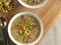 two bowls of soup on a wooden table