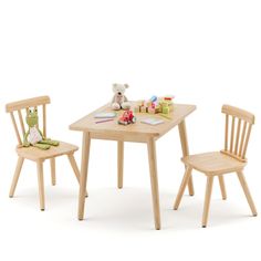 a wooden table with two chairs and a teddy bear