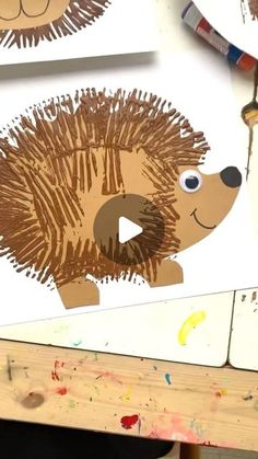 the hedgehog craft is being made with paper plates and crayon paint on it