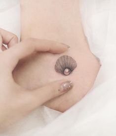 a close up of a person's stomach with a small tattoo on her belly