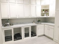 a kitchen with all white cabinets and marble counter tops is pictured in this image, it appears to be empty