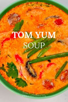 tom yum soup in a green bowl with the words tom yum soup above it