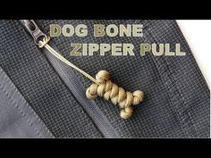 a close up of a tie with the words dog bone zipper pull written on it