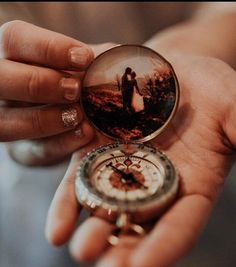 a person holding a compass in their hand with a photo on it's side