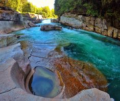 a river with blue water surrounded by rocks