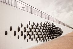 a white wall with black circles on it