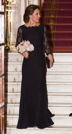 the duke and princess of cambridge are seen walking down stairs together in black gowns