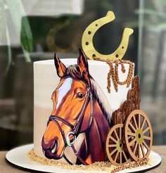 a cake with a horse drawn carriage on it's side and a cowboy hat on top