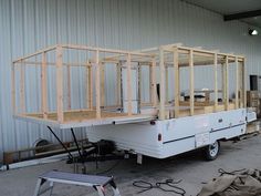 a white trailer sitting inside of a building under construction