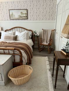 a bed room with a neatly made bed and a basket on the floor next to it