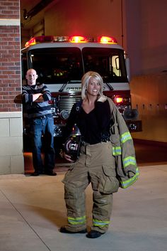 a woman standing in front of a fire truck