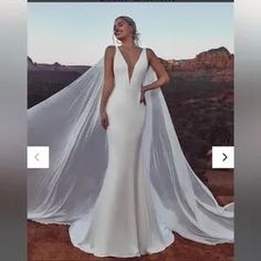 a woman in a white wedding dress standing on top of a mountain