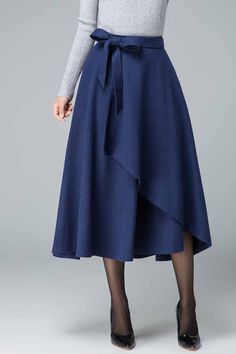 A removable tie belt beautifully cinches in the fitted waist of our feminine layered evening wool skirt. Elegant Belted Asymmetrical Wrap Skirt, Elegant Asymmetrical Belted Wrap Skirt, Blue Midi Skirt For Winter, Blue Lined Maxi Skirt For Fall, Blue Skirt For Workwear In Winter, Elegant Long Skirt With Tie Waist, Blue Asymmetrical Skirt For Work, Elegant Blue Skirt For Fall, Elegant Belted Asymmetrical Skirt