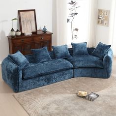 a blue couch sitting on top of a rug in a living room