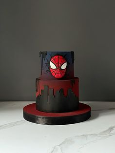 a spiderman themed cake on a table