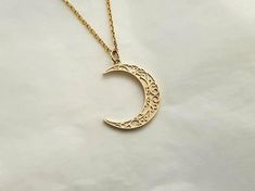 mens womens crescent moon necklace pendant made in 14k or 18k solid goldthe delicate patterns that make it more attractive are on the crescent moon pendant.model wears a 14k 1.7mm 50cm chain.free shipping on all orders via fedex!14k gold mens womens crescent moon pendant necklace weightpendant only 2.46g (±7%)with 1.4mm 42cm chain 5.11g (±7%)with 1.7mm 42cm chain 6.26g (±7%)with 2.2mm 42cm chain 8.21g (±7%)18k gold mens womens crescent moon pendant necklace weightpendant only 2.93g (±7%)with 1.4 Elegant Half Moon Brass Jewelry, Elegant Brass Jewelry With Moon Charm, Elegant Moon Shaped Brass Jewelry, 14k Gold Moon Charm Necklace In Half Moon Shape, 14k Gold Crescent Celestial Necklace, 14k Gold Half Moon Necklace With Moon Charm, Celestial Crescent 14k Gold Necklace, Elegant Engraved Moon-shaped Necklace, Elegant Moon-shaped Engraved Necklace