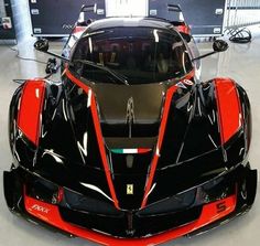 a black and red sports car parked in a garage