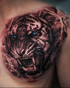 a close up of a man's chest with a tiger tattoo on it