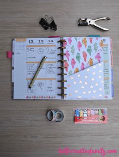 the contents of a planner spread out on a wooden table with scissors and other items