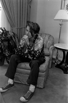 a man sitting on top of a couch in a living room