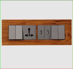 an electrical outlet on a wooden wall with two switches and one light switch in the middle