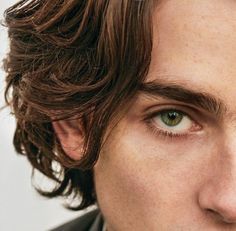 a man with freckles on his hair and green eyes