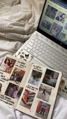 an open book sitting on top of a laptop computer next to a bed with white sheets