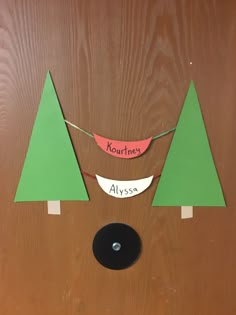 a door decorated with paper trees and a name tag