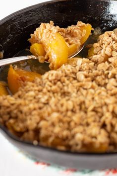 peach crisp w / canned peaches in a skillet with text overlay that reads peach crisp w / canned peaches