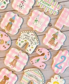 decorated cookies are arranged on a table for the first birthday boy and girl to be