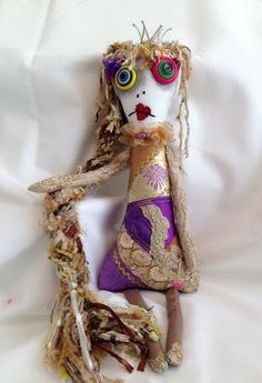 a doll made out of fabric and yarn