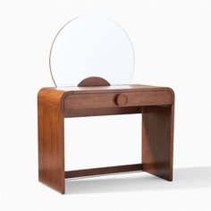 a wooden table with a mirror on it and a shelf underneath the mirror that has a circular mirror on top