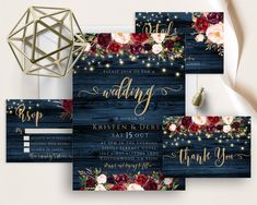 wedding stationery with flowers and string lights on wooden planks in navy blue background