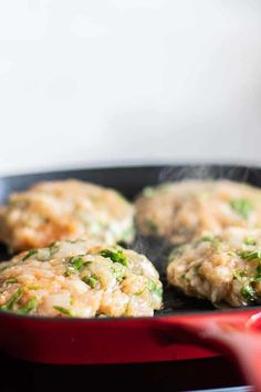 some food is cooking in a frying pan on the stove top and it looks like broccoli patties