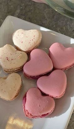 some heart shaped cookies are on a plate