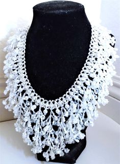 A handmade glass seed beaded necklace that is perfect for any occasion: parties, weddings, holidays, birthdays, anniversaries. All products are hand-crafted by my mother. Dimensions: - Collar Length: 20.5 cm - Actual Length: 29.0 cm - Width: 17.5 cm - Height: 7.0 mm Lightweight, high quality with a beaded hook as a clasp.  Acrylic Pearls: 8 mm. Will respond to concerns and suggestions promptly. Shipping costs: Free Domestic Shipping. All orders are sent by air-mail with tracking number. Time of delivery: Estimated 1-3 days for domestic shipping; international make take 7-14 days. Feel free to check out our other similar products! Link: https://noorsjewelers.etsy.com Adjustable Beaded Chain Necklaces For Wedding, Adjustable Beaded Chain Necklace For Wedding, Handmade White Crystal Necklaces For Wedding, White Necklaces With Round Beads For Celebrations, Handmade White Crystal Necklace For Wedding, White Necklace With Round Beads For Celebration, Handmade White Crystal Wedding Necklaces, Handmade White Crystal Necklaces With Round Beads, Handmade White Crystal Necklace With Round Beads