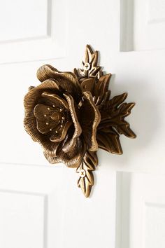 a close up of a door handle with a flower on it's center piece