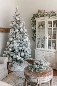 a white christmas tree in a living room