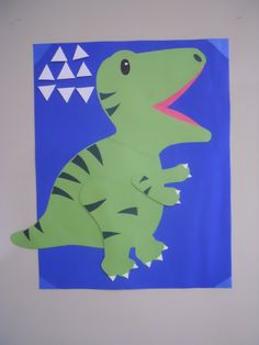 a paper cut out of a dinosaur on a blue background