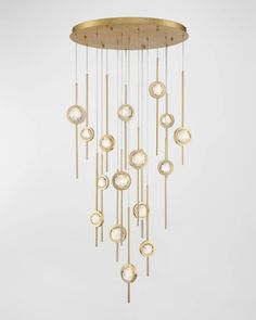 a chandelier made out of gold and white glass with lots of circles hanging from the ceiling