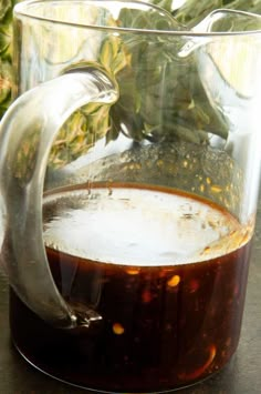 a pitcher filled with liquid sitting on top of a table