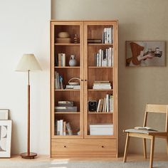 Build a calm reading space and learning environment in your home with this Ridge Organic Bookshelf. Fill your room with rich resource materials such as books, magazines, comics, pamphlets, and even your documents for work or school in this bookshelf. Crafted from carefully selected solid wood, this organic bookshelf is stable and is resistant to wear and decay. The treated wood is not easily discolored and prone to molds. A light color, elegant texture, and beautiful grain adds elegance and flair to your leaning or entertaining spaces. The spacious compartments allow you to display your favorite books and collectibles. Enjoy worry-free storage with the multiple open compartments for your frequently-accessed items and enclosed drawers to organize your clutter and keep your private items hid Book Shelves With Glass Doors, Organic Bookshelf, Bookcase With Storage, Modern Home Offices, Bookcase With Glass Doors, Large Bookcase, Dining Cabinet, Wooden Structure, Mold Growth